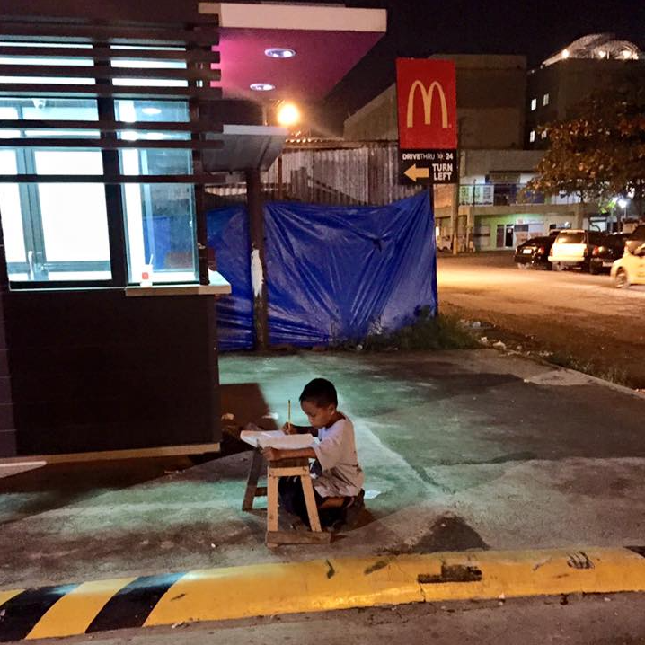 Daniel Cabrera - Filipino kid doing homework outside McDonald's